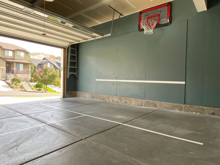 an empty garage with a basketball hoop on the wall