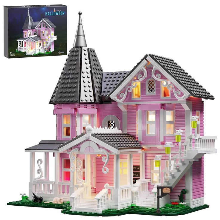 a pink and white doll house with lights on