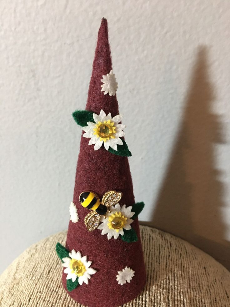 a red hat with flowers and bees on it