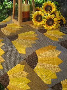 sunflowers and a lantern on a table