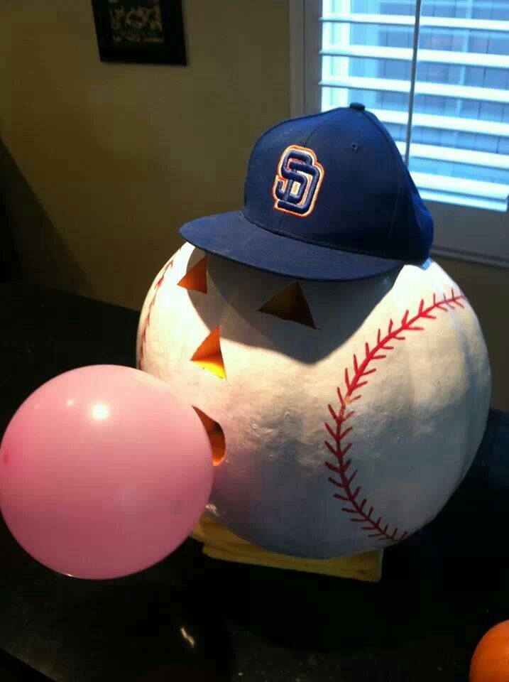 a baseball ball and balloon sitting on a table