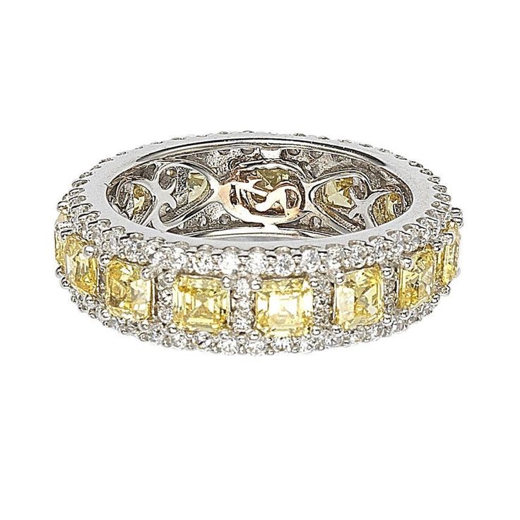 A stunning mix of colors that will last an eternity! This ring is filled with rich, tasteful color and modern fashion, featuring yellow-diamond color asscher-cut cubic zirconia, prong-set between two rows of white pave cubic zirconia, hand set in 925 sterling silver. Surprise someone special in your life with this luxurious anniversary ring. Yellow and white asscher and round-cut gemstones set in high-polish sterling silver setting create a ring that's not only strikingly gorgeous but reminds yo Modern Eternity Band, Levian Jewelry, Gemstone Brooch, Cubic Zirconia Bracelet, Cubic Zirconia Necklace, Cubic Zirconia Jewelry, Cubic Zirconia Earrings, Creating Jewelry, Jewelry Rings Diamond