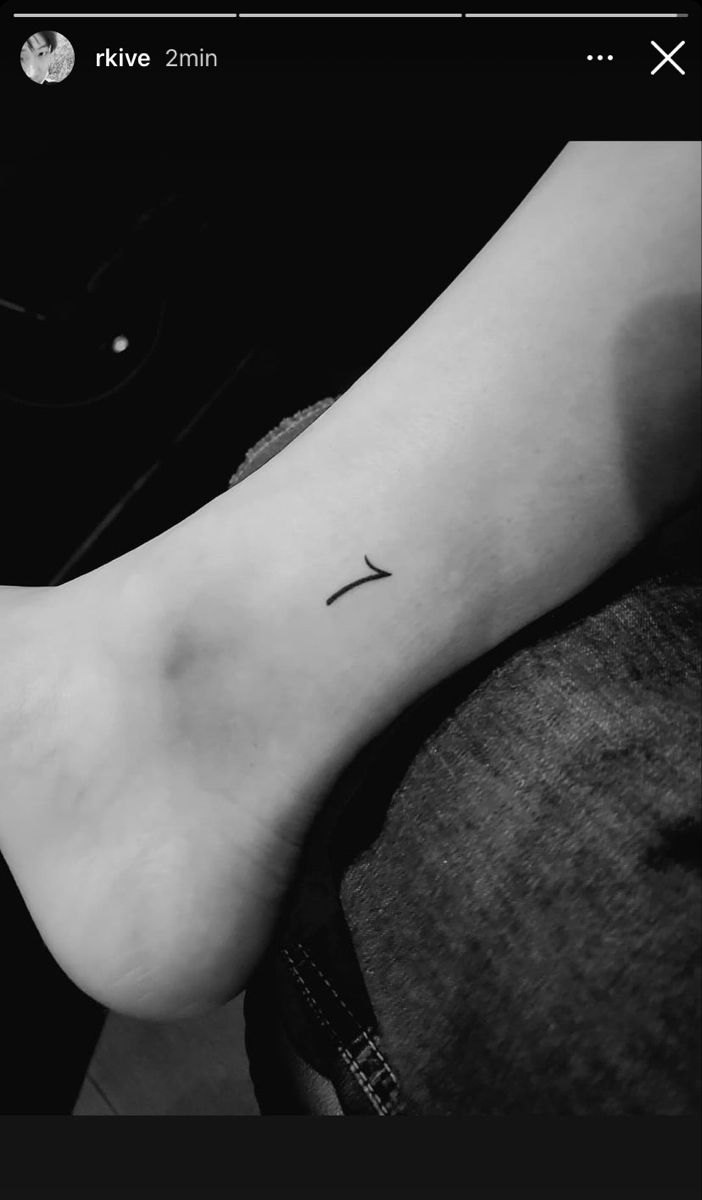 a black and white photo of a foot with a cross on it