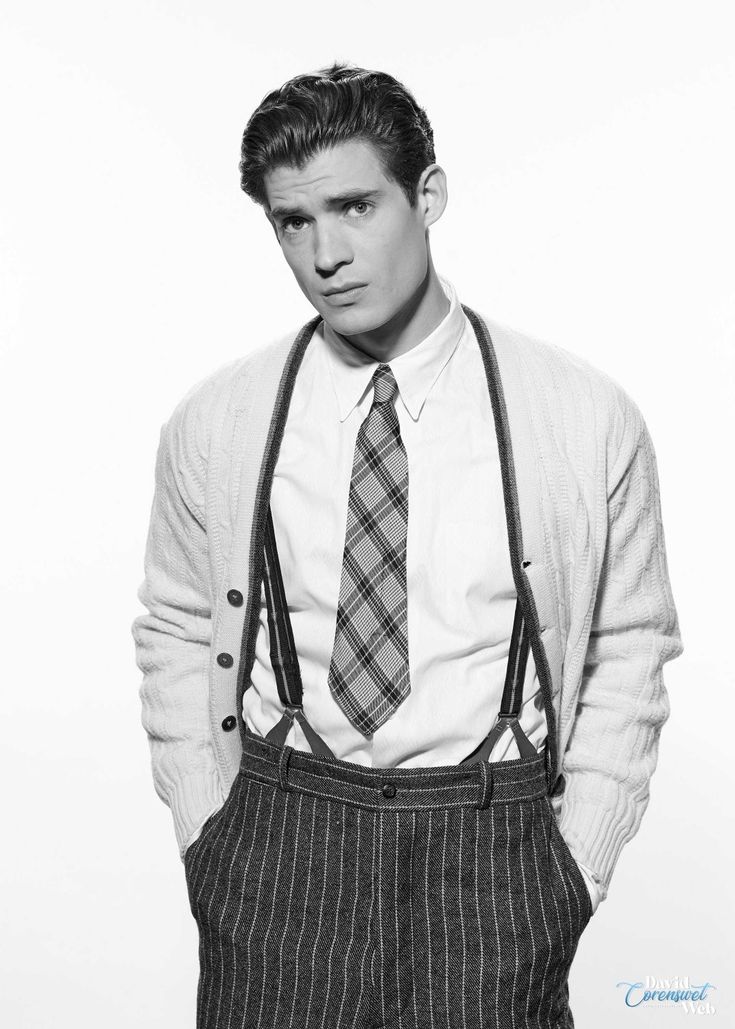 a young man wearing suspenders and a tie