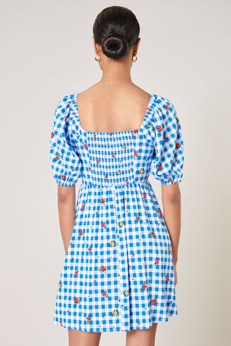 We're not in Kansas anymore! Reminiscent of the classic movie, this dress features a quintessential gingham print with a ditsy rosebud overlay. Short puff sleeves frame a flattering bodice with a sweetheart neckline. It sits atop a voluminous mini skirt, creating the perfect fit and flare. Wear it with red strappy heels or white sneakers for a casual look.- Smocked back- Sweetheart neckline- Fit and flare- Lined- Color: Blue RedSize + Fit - Model is 5'9" and wearing size XS- Measurements taken f Gingham Floral Print Dress For Picnic, Gingham Dress With Floral Print For Picnic, Fitted Gingham Dress With Floral Print, Not In Kansas Anymore, Red Strappy Heels, Puff Sleeve Mini Dress, Gingham Print, Mini Dress With Sleeves, Strappy Heels