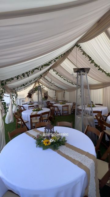 an outdoor tent with tables and chairs set up for a wedding or other function event