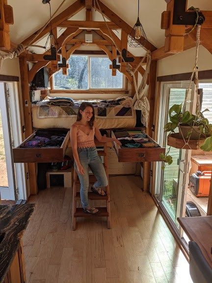 a woman sitting on a chair in a small room