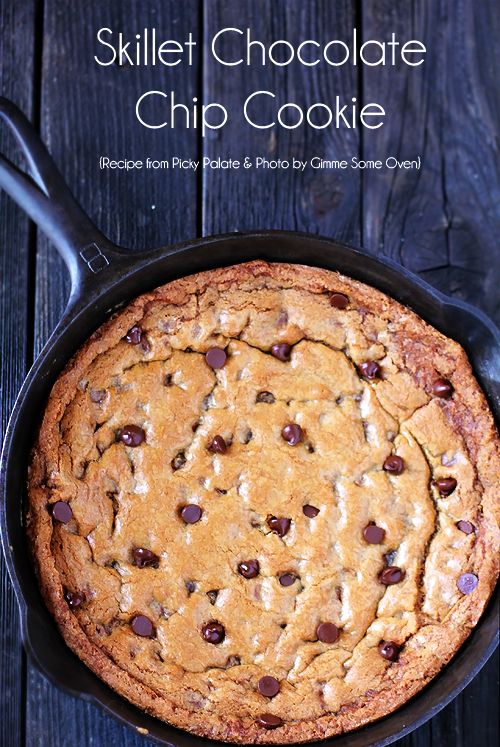 skillet chocolate chip cookie in a cast iron skillet on a wooden table with text overlay