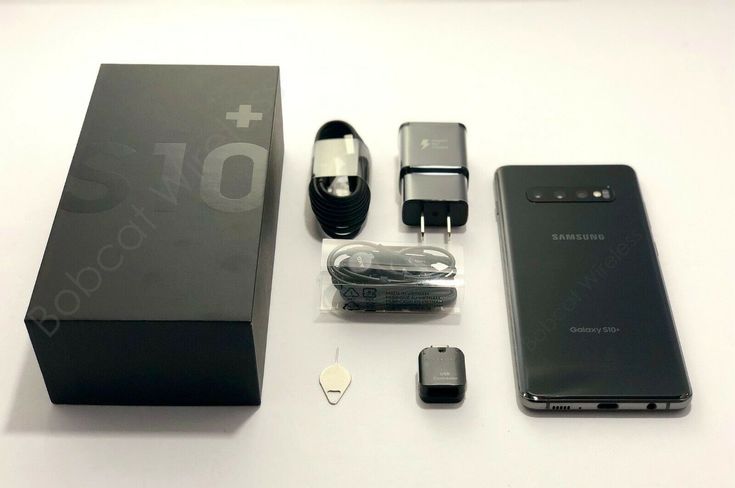 an assortment of electronic devices sitting on top of a white table next to a black box