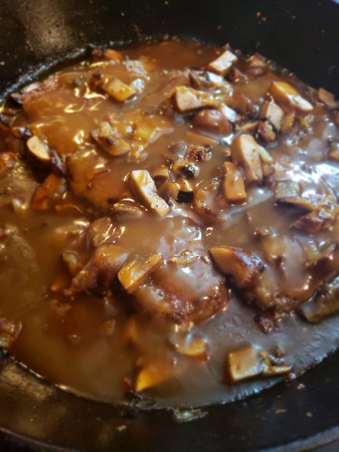 meat and gravy cooking in a skillet