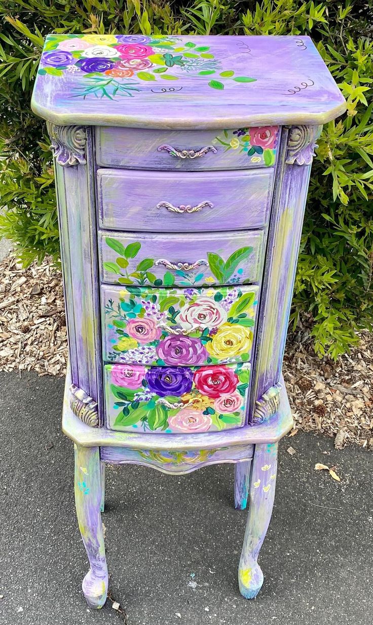 an old dresser painted with flowers on it