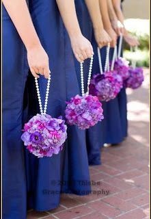 the bridesmaids are holding their purple bouquets