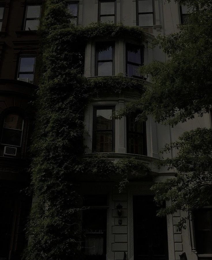 an old building with ivy growing on it's side