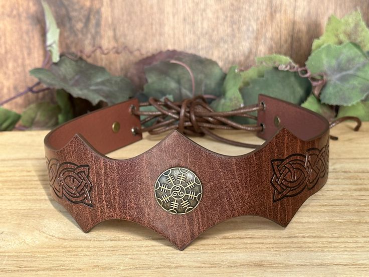 It is a fine leather circlet, with a metal compass mounted on it. The leather band is embossed with classic Celtic knot. And is held in place by lace at the back running through holes with metal. ADJUSTABLE One size fit all. You can make the leather headband adjustments to fit your head size with the lace rope. PERFECT FOR RENAISSSANCE FAIRS for Viking Warrior, suitable for the LARP, Fantasy Events, Comic Con, Halloween Cosplay Parties. This item it will send on First class mail (2 to 5 business Ren Fair Men, Leather Circlet, Warrior Crown, Medieval Headpiece, Leather Headband, Ren Fair, Leather Headbands, Viking Warrior, Mens Costumes