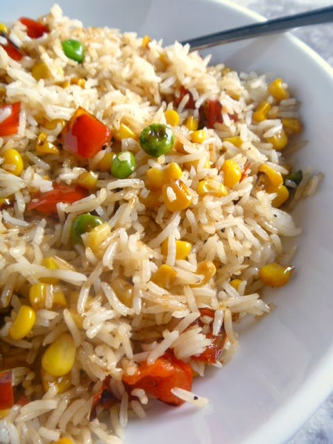 a white bowl filled with rice and vegetables