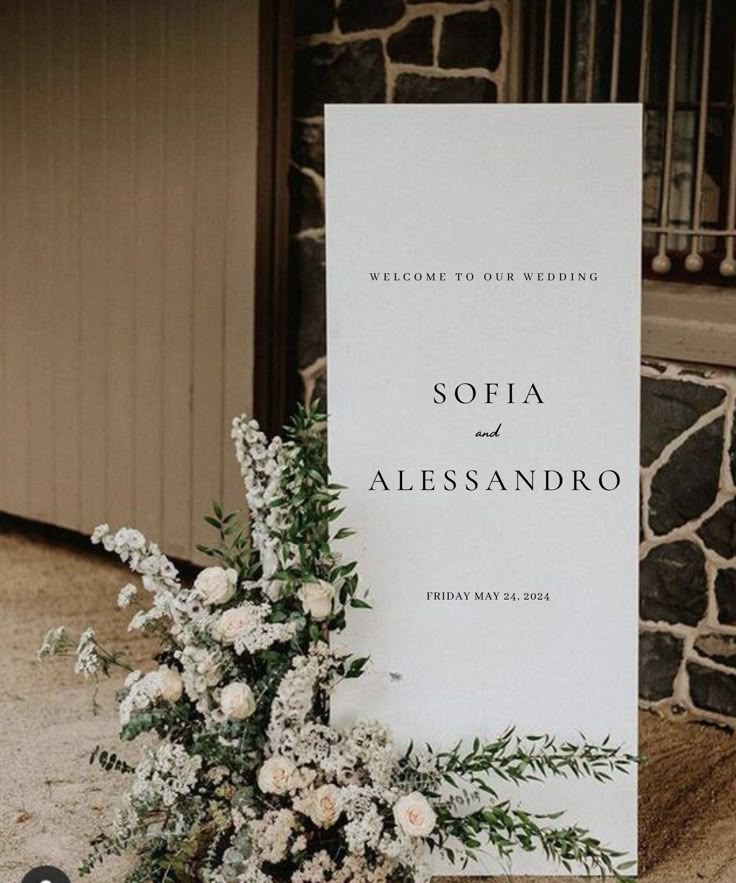 a sign that says sofia and alessandro is next to some flowers