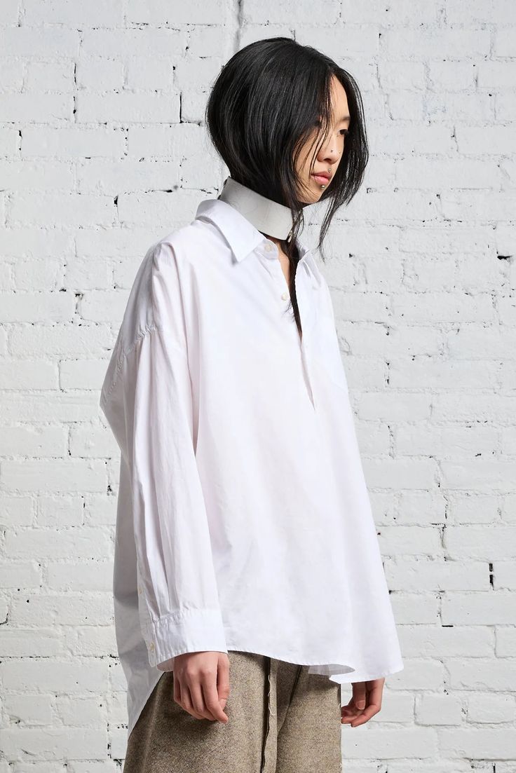 Color: White Classic drop neck shirt Front pocket/ button up Oversized - Order size down Model is 5’11” and wearing size M Bust 34”; waist 24”; hips 35” Machine wash cold, Do not tumble dry 100% Cotton Imported R13W7469-001 White Blouse With Shirttail Hem And Placket, Oversized White Blouse With Placket, White Relaxed Fit Blouse With Placket, White Blouse With Relaxed Fit And Placket, Everyday White Shirt With Placket, White Collared Top With Placket, White Shirt With Placket, White Collared Shirt With Placket, Everyday White Blouse With Placket