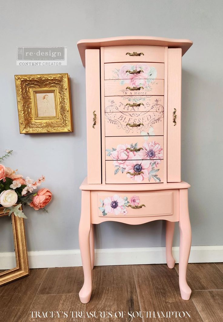 a pink dresser with flowers painted on it