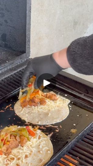 two tortillas being cooked on top of an open grill with someone's hand