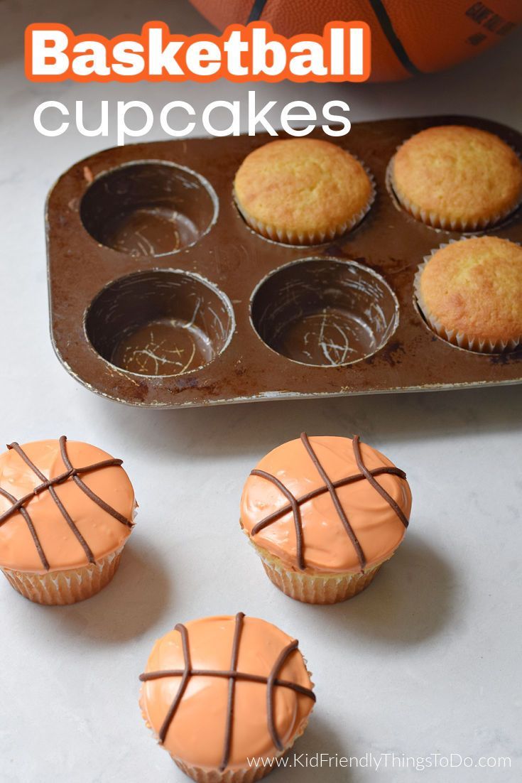 basketball cupcakes with orange frosting in a muffin tin on a table