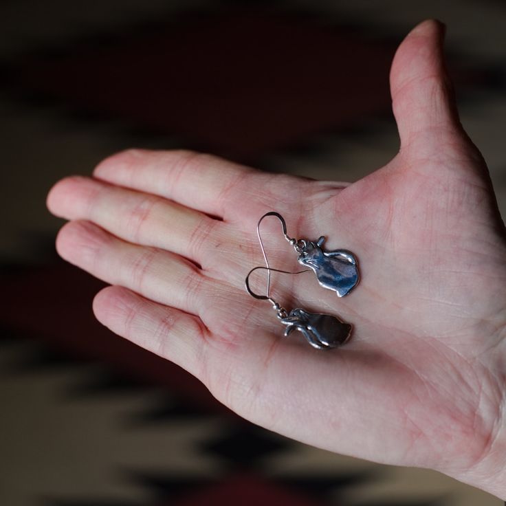 "This pair of cat lady earrings are stylized and elegant. They could be worn practically anywhere! They would make an endearing cat lover gift. Since they represent a young cat or kitten, they are especially unique. And they capture those early months of an adored pet's life. Handcrafted, cast and finished to a beautiful sheen in the USA, they were designed by a true-cat loving artist. Each earring is about 3/4\" tall and 1/2\" wide. The Magic Zoo's unique sterling silver jewelry has been create Elegant Cat Ears Jewelry With Cat Design, Elegant Cat Ears Jewelry Gift, Silver Cat Ears Jewelry, Nickel-free Cat Ears Jewelry For Gifts, Nickel-free Cat Ears Jewelry Gift, Hypoallergenic Cat Ears Jewelry For Gift, Hypoallergenic Silver Cat Ears Jewelry, Silver Cat Design Jewelry With Cat Ears, Sterling Silver Cat Ears Earrings Gift