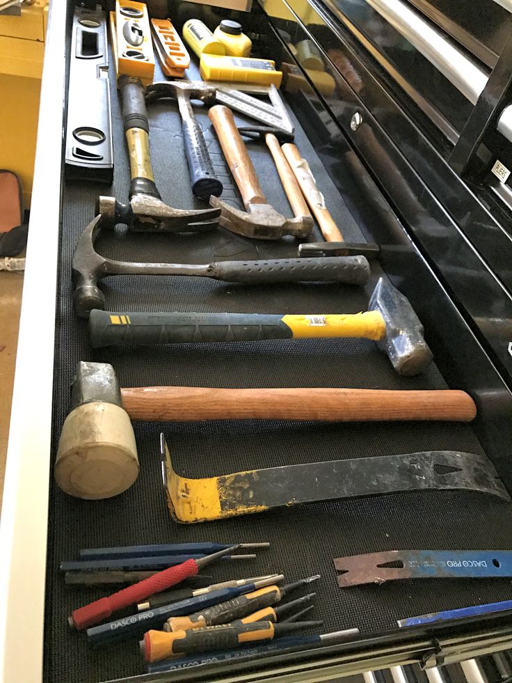 an assortment of tools are sitting in a drawer