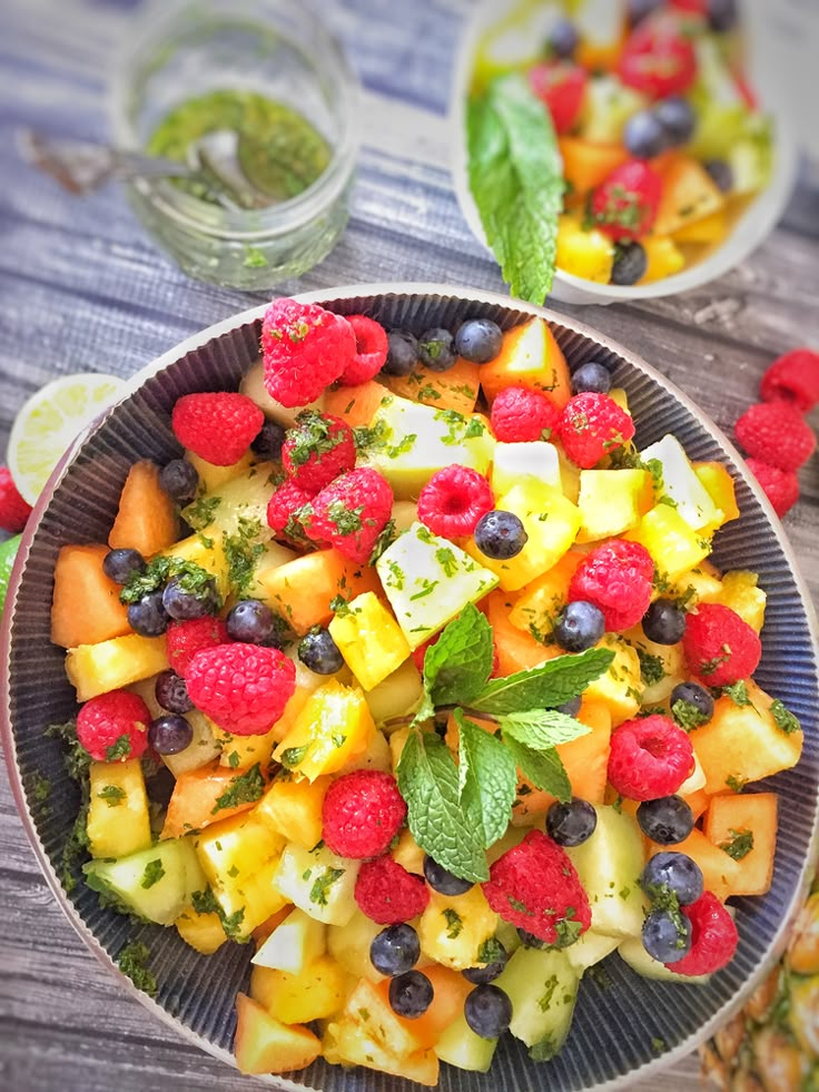 fruit salad with raspberries, pineapples and mint