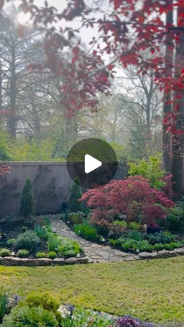 a garden with lots of trees and flowers in it, surrounded by foggy skies