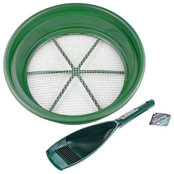 a green plastic strainer and spatula next to it's contents on a white background