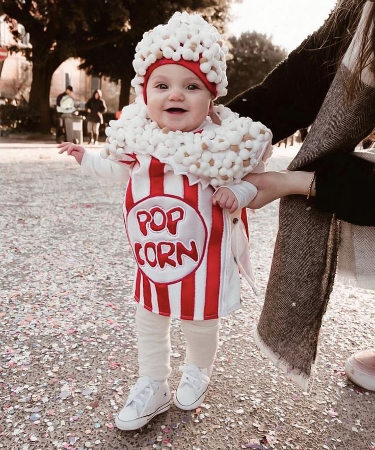 a small child wearing a popcorn costume