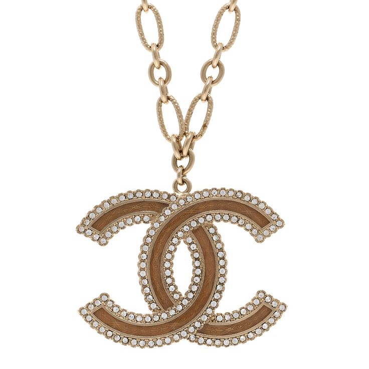 This is an authentic CHANEL Crystal Glass CC Necklace in Light Gold. This eye-catching necklace features a CC logo pendant crafted of light beige enamel inlay trimmed with gold detail and encrusted crystals. Cc Necklace, Chanel Necklace, Gold Chanel, Chanel Jewelry, Cc Logo, Gold Details, Light Beige, Crystal Glass, Pendant Jewelry