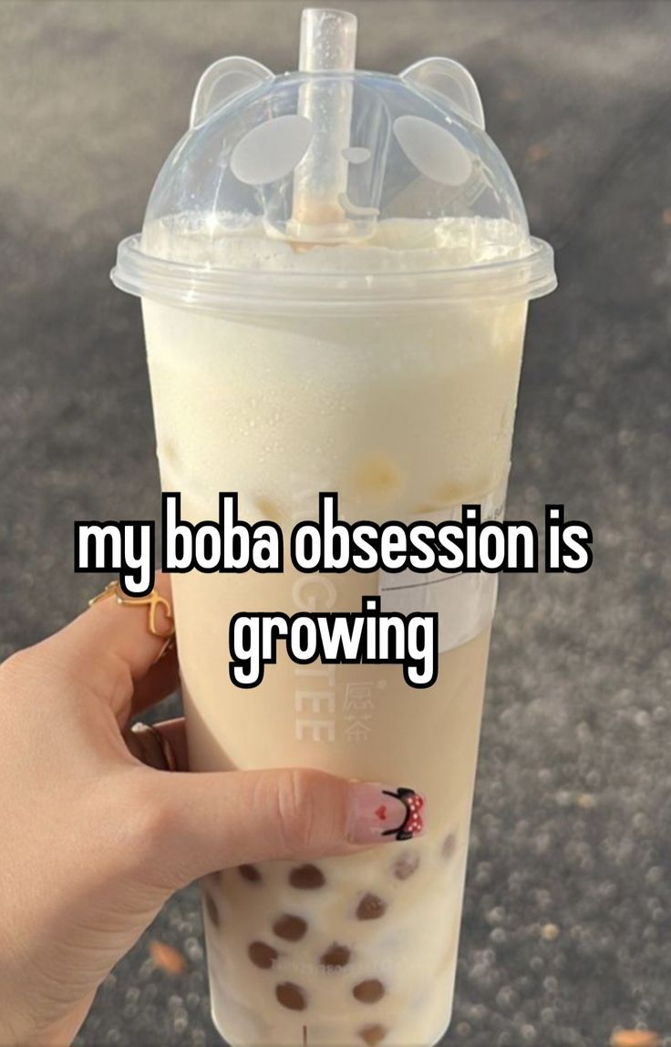 someone holding up a drink with the words my boba possession is growing on it