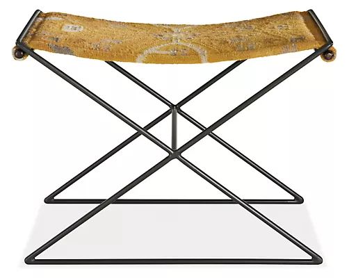 an iron and wood folding chair with yellow fabric seat pad, designed by person in the early 20th century