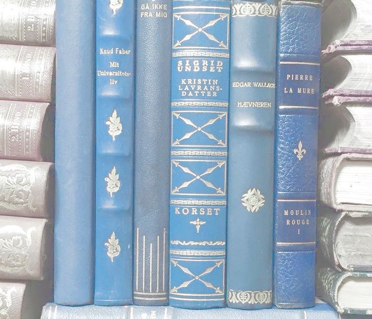 several blue books are stacked on top of each other