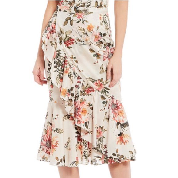 From Antonio Melani, This Skirt Features: Pencil Silhouette Ruffle Hemline Wrap Side Ruffle Floral Motif Invisible Zip; Hook/Eye Center Back Approx: 30.75" Length Cotton Polyester/Elastane Lining Dry Clean Imported. Chic Tiered Skirt For Garden Party, Elegant Knee-length Ruffled Bottoms, Elegant Ruffled Skirt For Garden Party, Spring Midi Bottoms With Ruffle Hem, Ruffled Midi Skirt For Brunch, Elegant Spring Bottoms For Brunch, Elegant Bottoms For Summer Garden Party, Elegant Summer Bottoms For Garden Party, Ruffled Bottoms For Spring Garden Party