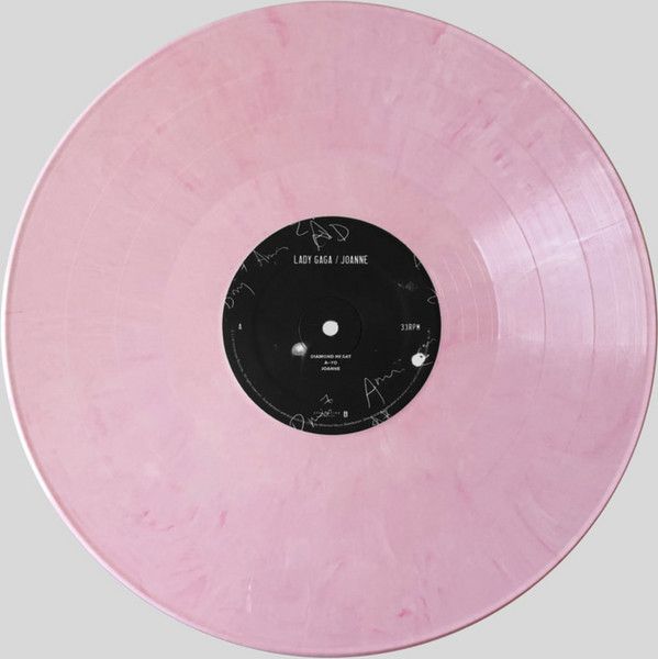 a pink vinyl record with writing on it