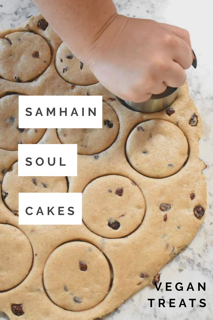 a person is cutting out cookies on a cookie sheet with the words samahn, soul cakes and vegan treats