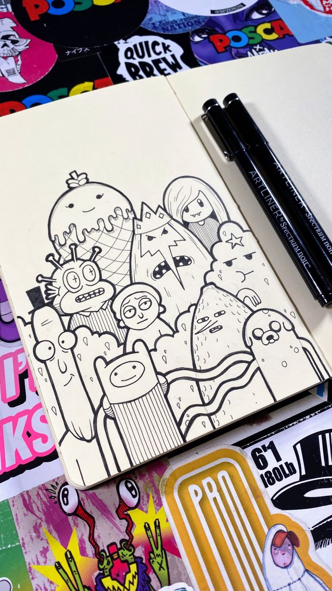 an open notebook with cartoon characters on it next to some markers and sticker sheets