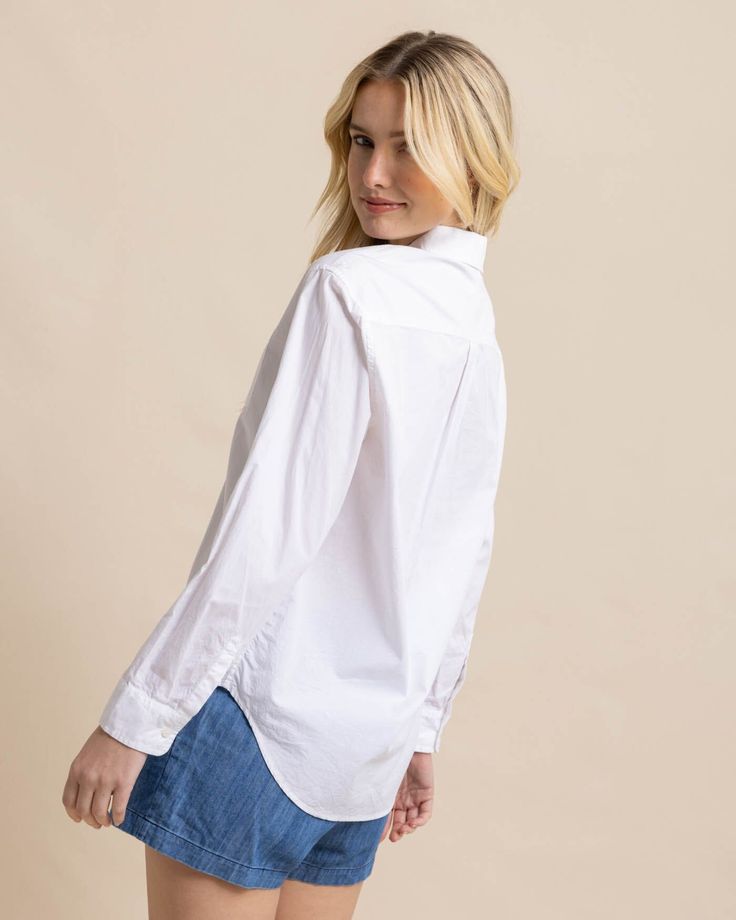 Crisp, clean, and classic, our essential white button-down is fresh and versatile. The button cuffs can be styled longer or shorter, and the button-tail hem provides different looks when tucked in or left out. This 100% cotton top is comfortable from the desk to the dock. Style: 10872 White Poplin Tops With Button Cuffs, Solid Shirt With Button Cuffs For Everyday Wear, Classic Poplin Tops With Button Cuffs, White Poplin Button-up Shirt, White Relaxed Fit Poplin Shirt, Classic Everyday Button-up Dress Shirt, Everyday Classic Button-up Dress Shirt, Classic Shirt With Shirttail Hem For Everyday, Casual Poplin Tops With Button Cuffs