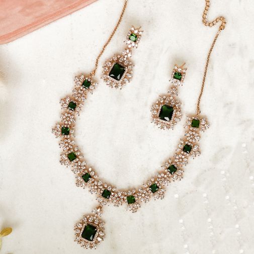 For edgy style and sophisticated sparkle, this necklace set is a dream come true! Elegant and shimmering set with CZ and emerald stones creating a flawlessly fresh finish for each and every one of your evening ensembles. The set includes a necklace, and a pair of beautiful earrings. Approximate earrings length is 2.1". Designed over a high-quality brass as base metal. Available in 3 plating options. Almina Set (Gold) is in-stock & ready-to-ship. Delivery time frame for Almina Set (Rose Gold) & ( Emerald Jeweled Jewelry For Parties, Sparkling Green Crystal Jewelry, Dazzling Emerald Necklaces For Party, Dazzling Emerald Necklace For Party, Green Sparkling Stones Jewelry Sets For Party, Hand Set Emerald Necklace With Cubic Zirconia For Party, Green Crystal Jewelry Sets With Sparkling Stones, Green Jewelry Sets With Diamond Accents For Party, Hand Set Cubic Zirconia Emerald Necklace For Party