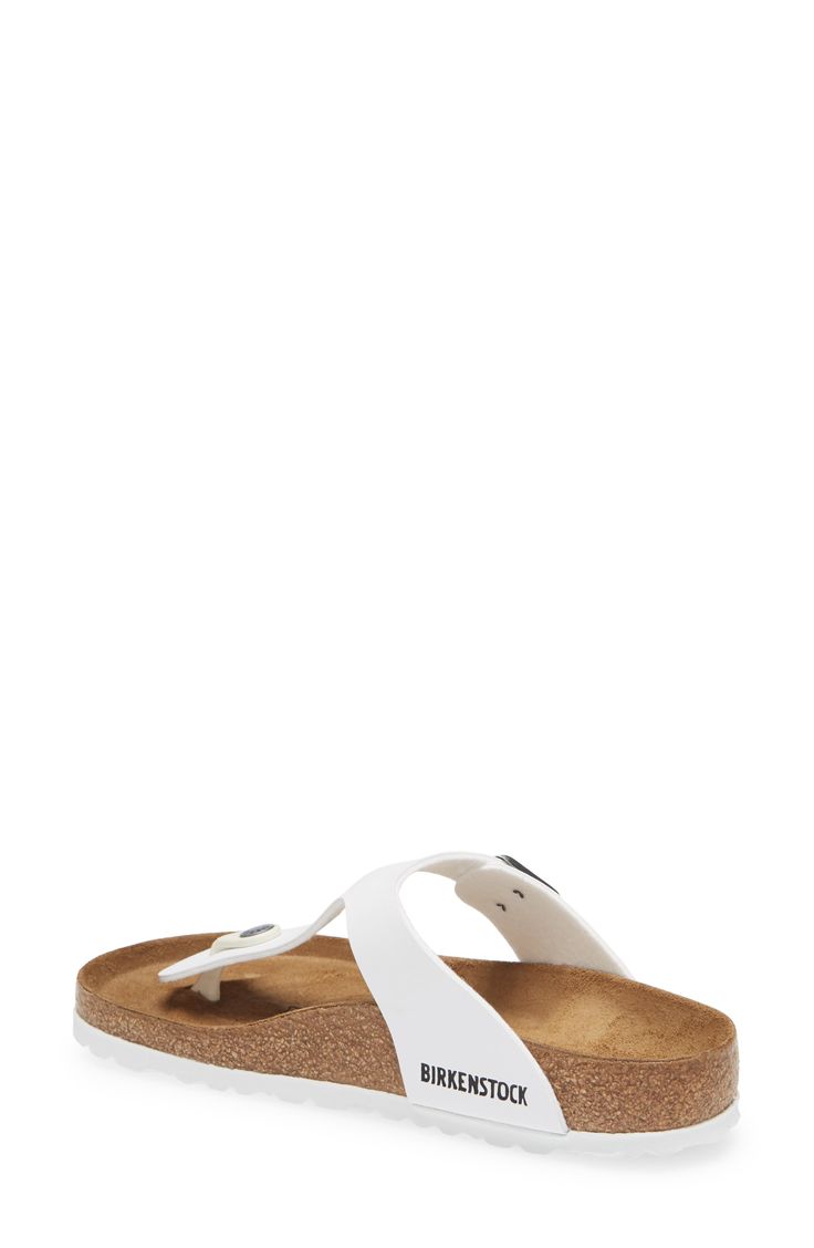 Available in an array of colors, this flip-flop is fitted with a molded footbed and topped with a Birko-Flor strap, cut from fabric with a leather-like finish. The toe piece is made of flexible resin, anatomically designed to fit comfortably between the toes, and the soft suede insole absorbs moisture and feels great against the skin. Adjustable strap with buckle closure Contoured footbed with arch support Synthetic upper/leather and textile lining/synthetic sole Imported Women's Shoes White Slip-on Footbed Sandals With Arch Support, T-strap Textured Footbed Sandals For Beach, Beach T-strap Sandals With Textured Footbed, Synthetic Slides With Cushioned Footbed And Toe Post, Synthetic Toe Post Slides With Cushioned Footbed, White Toe Post Sandals With Textured Footbed, White Textured Toe Post Sandals, White Toe Post Sandals With Cushioned Footbed, White Synthetic Flip Flops With Single Toe Strap