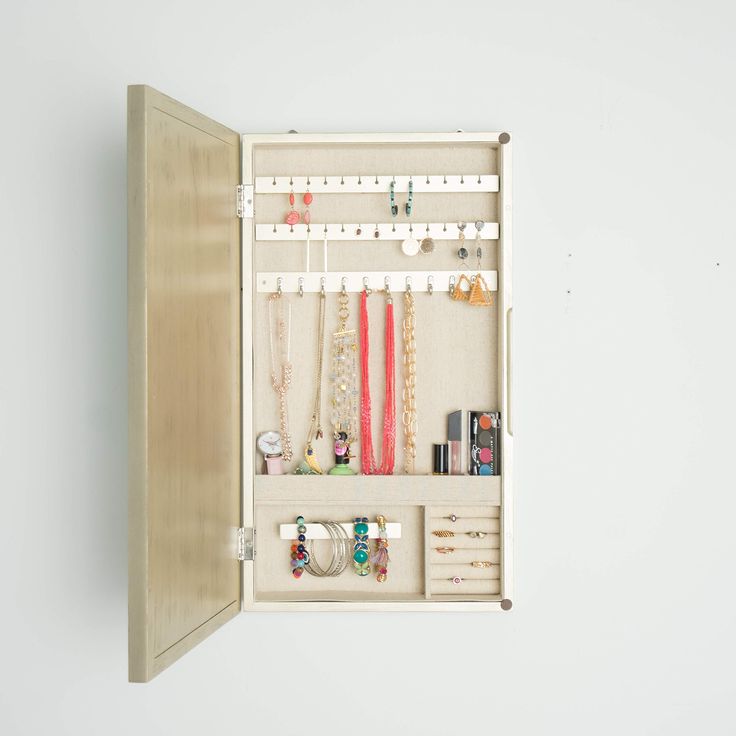 PRICES MAY VARY. Wall hanging jewelry storage mirror Storage options include 25 earring hooks, 10 necklace hooks, 7 divided compartments, a bracelet bar and ring rolls The inside is lined with a anti-tarnish linen Easy opening access design Includes mounting hardware Item Dimensions 3. 2 x 13. 5 x 24 inches Apartment Closet, Hanging Jewelry Storage, Jewlery Holder, Champagne Jewelry, Bracelet Bar, Jewelry Organizer Wall, Jewelry Wall, Hanging Jewelry Organizer, Jewelry Organizer Storage