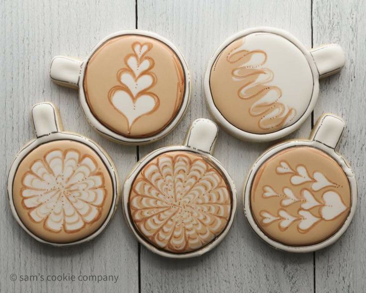 four coffee cup magnets with designs on them