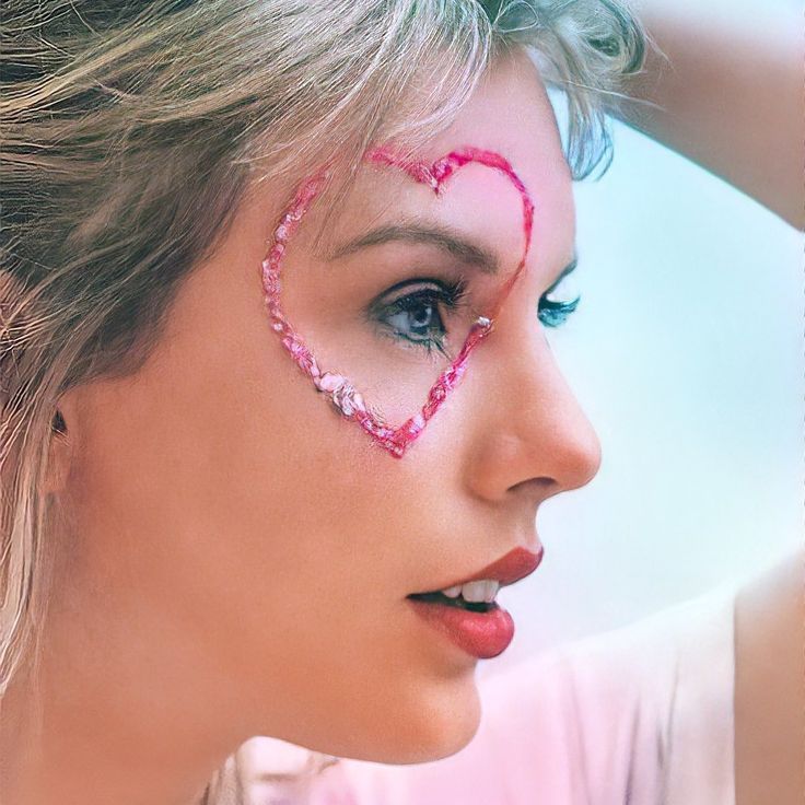 a woman with her face painted like a heart and wearing pink beaded eyeliners