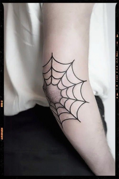 a person with a spider web tattoo on their arm