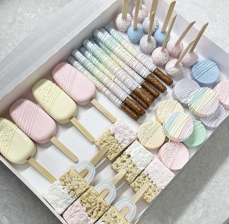 a box filled with lots of different types of marshmallows and lollipops