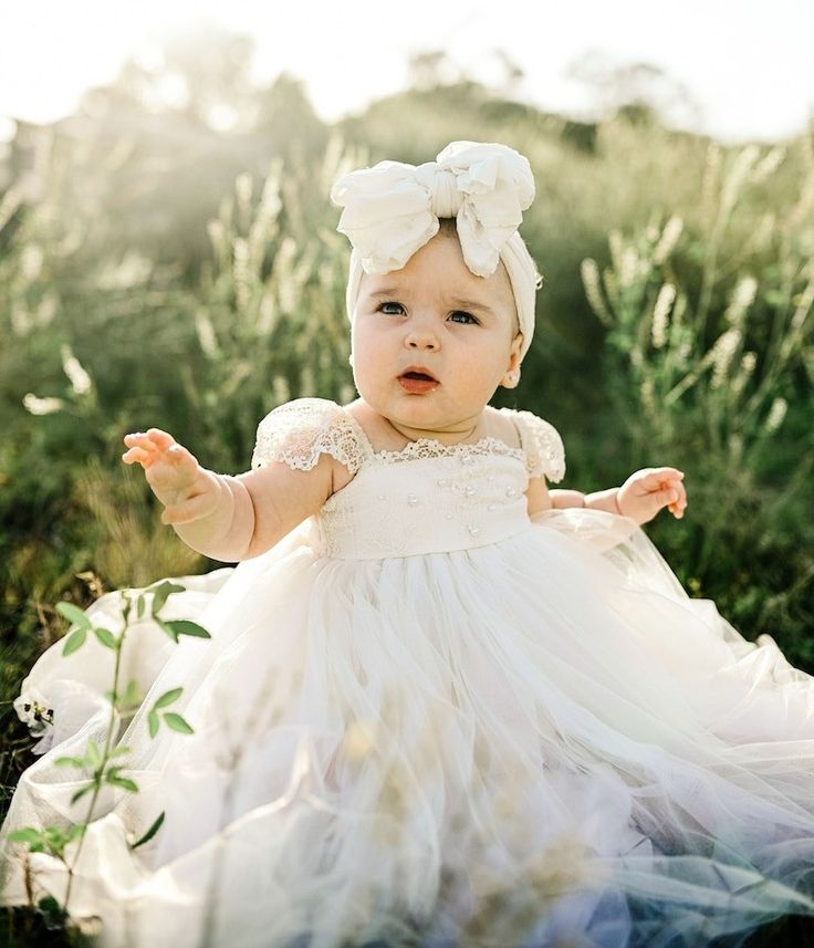 Desert sand background , a very cute little girl is wearing a white dress made of tulle and a beautiful lace, adorable cup sleeves and elegant lace edges and little pearls are showed in a sunlight White Baptism Dress, Cake Outfit, Girls Baptism Dress, Blessing Dress, First Birthday Dresses, Baptism Gown, Ivory Flower Girl