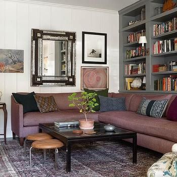 a living room filled with furniture and bookshelves covered in lots of bookcases