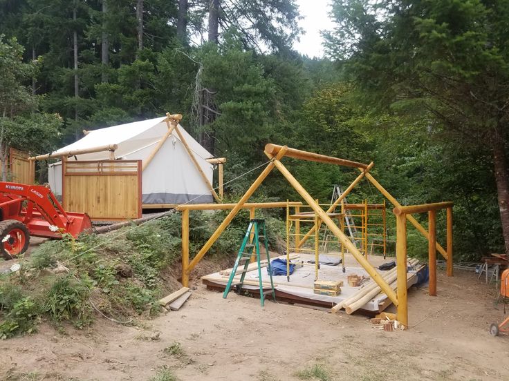 an outdoor structure is being constructed in the woods