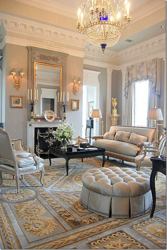 a living room filled with furniture and a chandelier